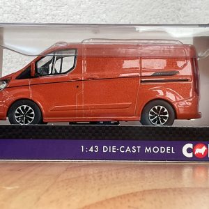 Side view of red Ford Transit die-cast model in packaging