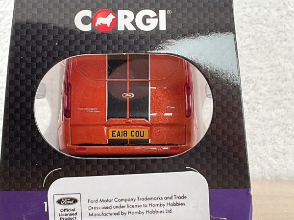 Rear view of red Ford Transit die-cast model in box