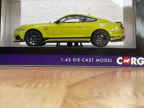 Side view of yellow Ford Mustang Mach 1 die-cast model in Corgi packaging