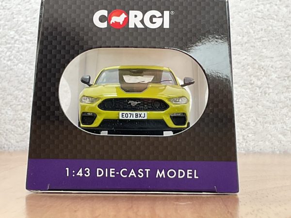 Front view of 1:43 scale Corgi die-cast Ford Mustang Mach 1 in lime green with EO71 BXJ plate in display packaging