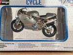 1:18 scale model of a silver Ducati motorcycle by Bburago in original packaging