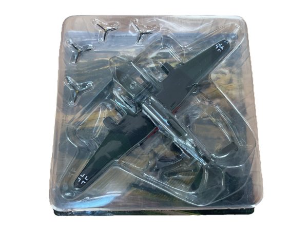 Diecast model of a German WWII military aircraft with swastika insignia, encased in clear plastic packaging